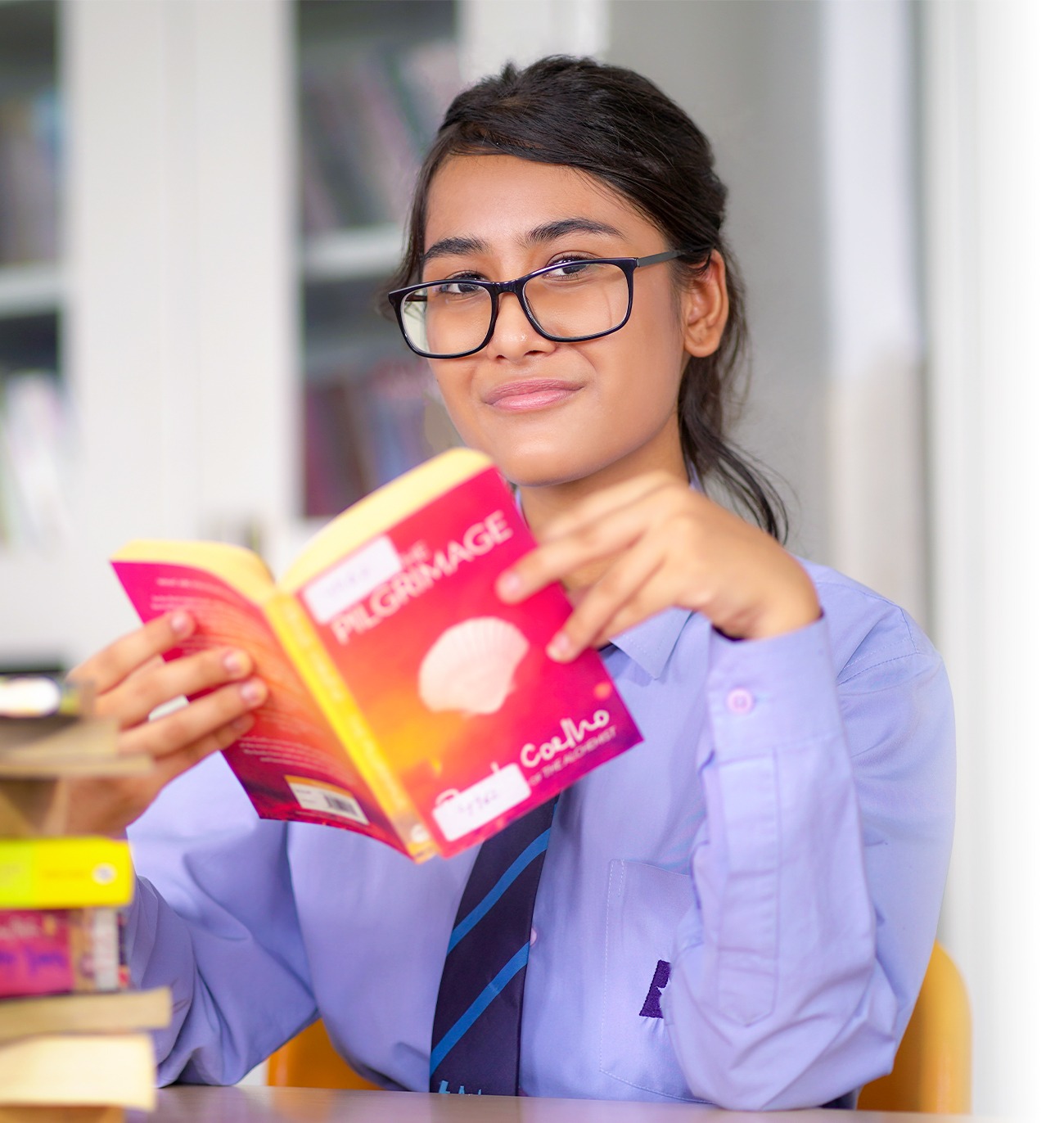 Aster student reading a book